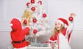 Kids in santa hats decorating christmas tree. Family tradition concept. Children decorating christmas tree together. Boy