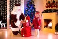 Kids and Santa opening Christmas presents Royalty Free Stock Photo