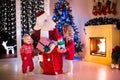 Kids and Santa opening Christmas presents Royalty Free Stock Photo