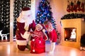 Kids and Santa opening Christmas presents Royalty Free Stock Photo