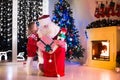 Kids and Santa opening Christmas presents Royalty Free Stock Photo