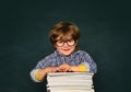 Kids school. Cute little preschool kid boy in a classroom. Schoolboy. Home schooling. Blackboard background - copy space Royalty Free Stock Photo