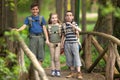 Kids scouts traveler with backpack hiking on bridge Royalty Free Stock Photo