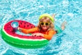 Kids on sea beach. Cute funny child boy relaxing with toy swimming ring in a swim pool having fun during summer vacation Royalty Free Stock Photo