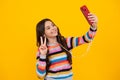 Kids selfie. Teenager child girl holding smartphone. Hipster girl with cell phone. Kid hold mobile phone texting in Royalty Free Stock Photo