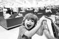 Kids shopping. Joyful beautiful child boy in supermarket buys vegetables. Healthy food for children. Cute kid with smile Royalty Free Stock Photo