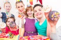 Kids showing muffin cakes at birthday party