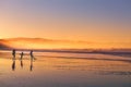 Kids silhouette playing and having fun in beach at sunset Royalty Free Stock Photo