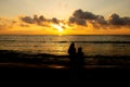 Kids in silhouette watching the sunrise in Marina Beach, Chennai, India Royalty Free Stock Photo