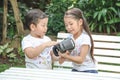 Kids Sister holding virtual reality, vr for boy younger brother to play VR experience is happy