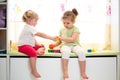 Kids sisters play together indoors Royalty Free Stock Photo