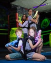 Kids sitting back to back with laser guns Royalty Free Stock Photo