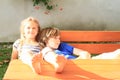 Kids sitting behind wooden table Royalty Free Stock Photo