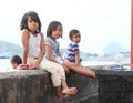 Kids sitting on railings in Labuan Bajo