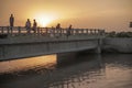 Kids Sitting Water From A Bridge During Sunset, In Moro