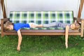 Kids sleeping on a garden swing Royalty Free Stock Photo