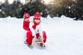 Kids on sleigh. Children sled. Winter snow fun