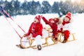 Kids on sleigh. Children sled. Winter snow fun