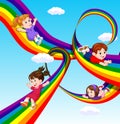 Kids sliding on rainbow in sky Royalty Free Stock Photo