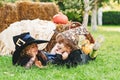 Kids smiling on a Halloween party. Happy Halloween Cute children daughter and son making funny faces with a pumpkin Royalty Free Stock Photo