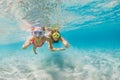 Kids in snorkeling mask dive underwater in blue sea lagoon Royalty Free Stock Photo
