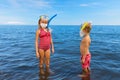 Funny kids in surgical face mask on sea beach