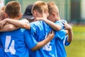 Kids soccer team with coach in group huddle before the match Royalty Free Stock Photo