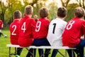Kids Soccer Team Players Sitting on a Bench on a Sunny Day Royalty Free Stock Photo