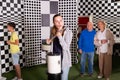 Kids solving conundrum in escape room and grandparents watching them