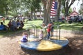 Kids spin on playground in Town Park