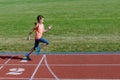 Kids sport, child running on stadium track, training and fitness