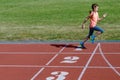 Kids sport, child running on stadium track, training and fitness