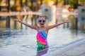 Portrait of cute happy little girl having fun in swimming pool. Royalty Free Stock Photo