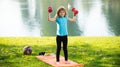 Kids sport. Healthy kid boy with dumbbell exercise outdoor. Little child practice dumbbells exercises in park.