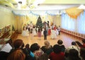 Kids stand around Christmas tree