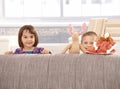 Kids standing behind sofa