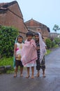 Kids standing and protecting themselves from rain