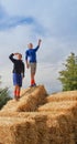 Kids standing on top of hay bales Royalty Free Stock Photo