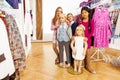 Kids standing with two mannequins in shop Royalty Free Stock Photo