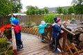 Kids standing on a wooden bridge of a miniature park