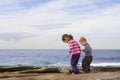 Kids stepping in rockpools Royalty Free Stock Photo