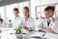 Kids or students with plant at biology class Royalty Free Stock Photo