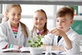 Kids or students with plant at biology class Royalty Free Stock Photo