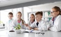 Kids or students with plant at biology class Royalty Free Stock Photo