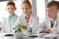 Kids or students with plant at biology class Royalty Free Stock Photo