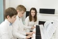 Kids Studying and Playing Piano in Tandem