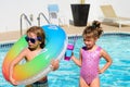 Kids summer vacation. Couple of children rest in swimming pool.