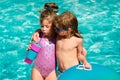 Kids summer weekend holidays. Summertime vacation. Couple of children in swimming pool. Royalty Free Stock Photo