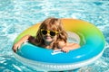 Kids summer weekend. Summertime vacation. Boy in swiming pool. Kid at aquapark. Happy boy on inflatable rubber circle.