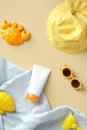 Kids sunscreen cream tube with baby sunglasses, panama hat, towel, sand molds. Baby sun protection concept Royalty Free Stock Photo